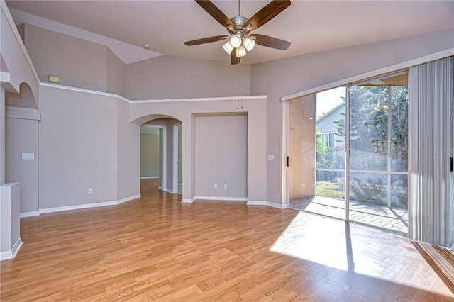 empty room with light wood-type flooring, plenty of natural light, ceiling fan, and lofted ceiling