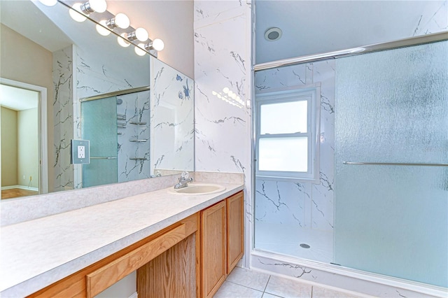 bathroom featuring tile patterned flooring, vanity, and a shower with shower door