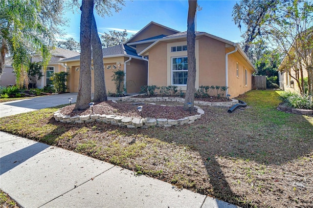 view of front of property with a garage and a front lawn