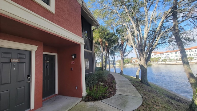 view of exterior entry with a water view