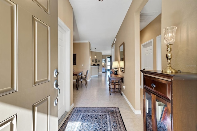 foyer entrance with light tile patterned floors and an inviting chandelier