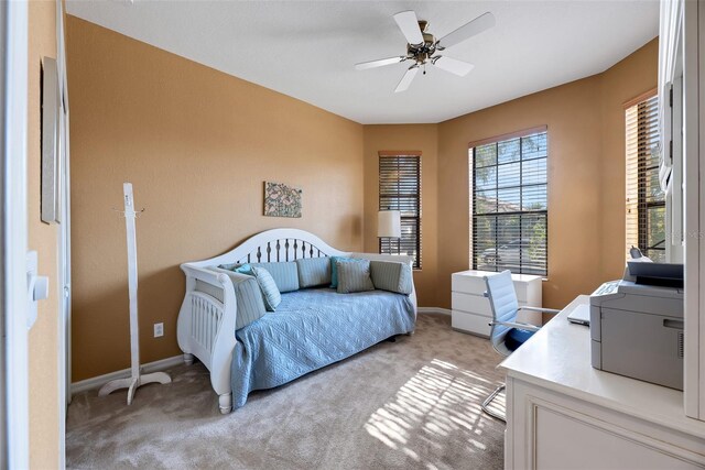 bedroom with ceiling fan and light colored carpet