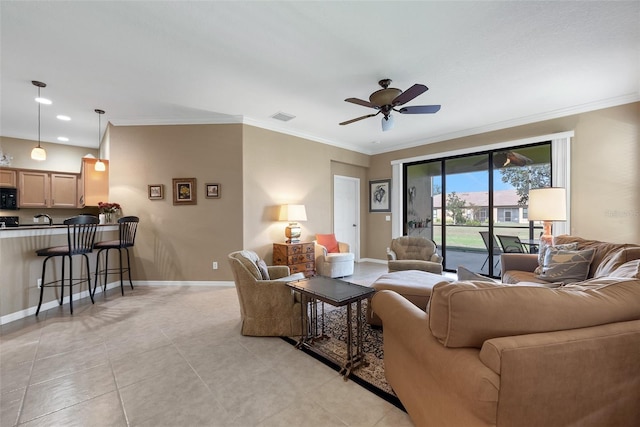 living room with ceiling fan, ornamental molding, and light tile patterned flooring