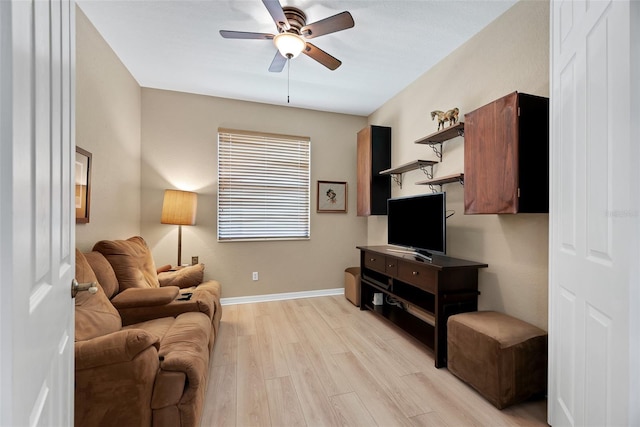 living room featuring ceiling fan and light hardwood / wood-style flooring