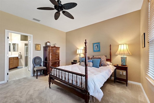 carpeted bedroom featuring ensuite bath and ceiling fan