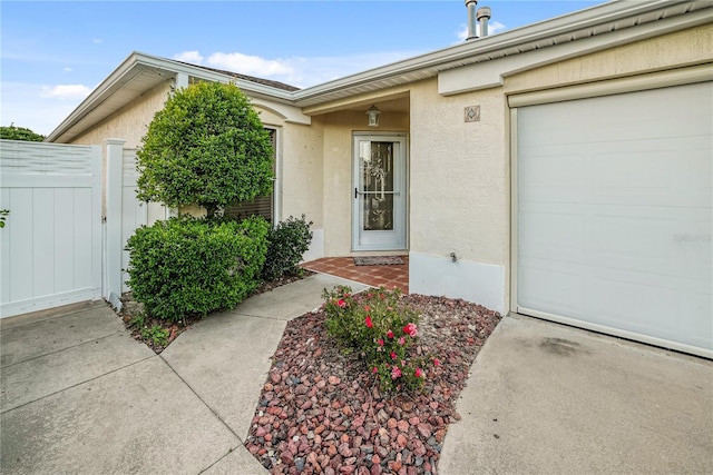 doorway to property with a garage