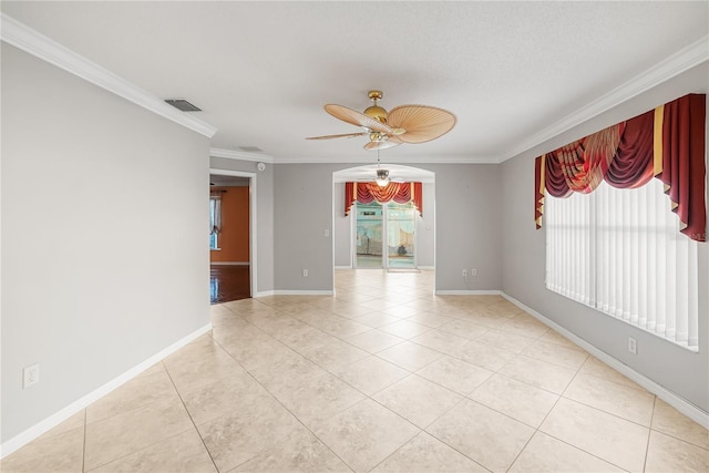 tiled empty room with ceiling fan and ornamental molding