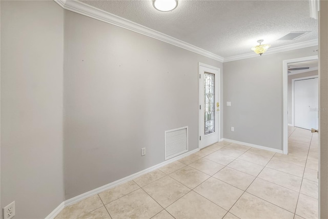 empty room featuring crown molding, light tile patterned floors, and a textured ceiling