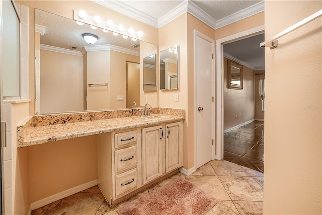 bathroom with tile patterned floors, vanity, ornamental molding, and a textured ceiling