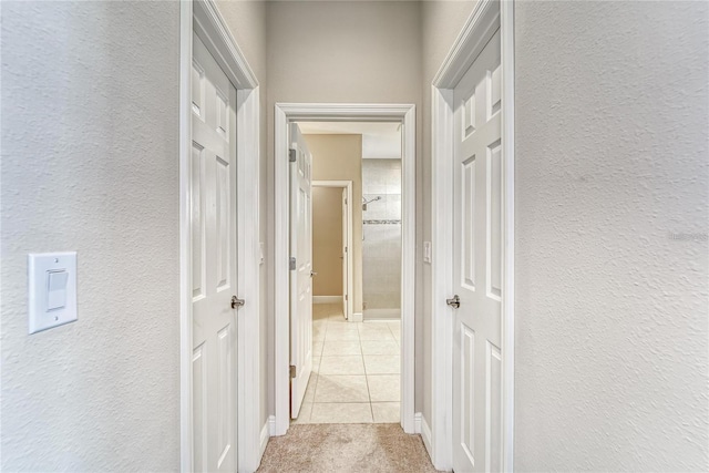 corridor with light tile patterned floors