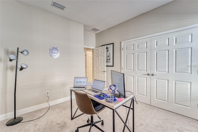 office area featuring light colored carpet and a textured ceiling