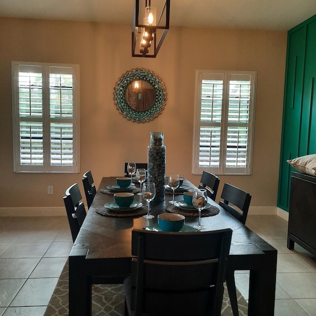 tiled dining space featuring plenty of natural light