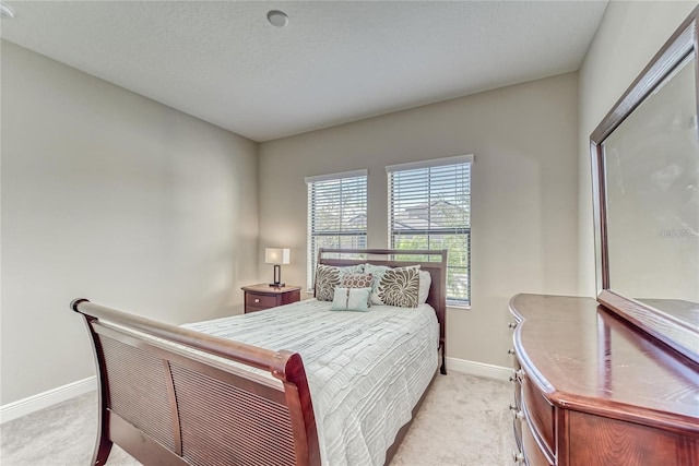 carpeted bedroom featuring a textured ceiling