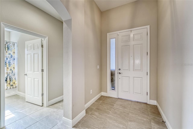 foyer entrance with light tile patterned floors