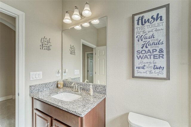 bathroom featuring vanity and toilet