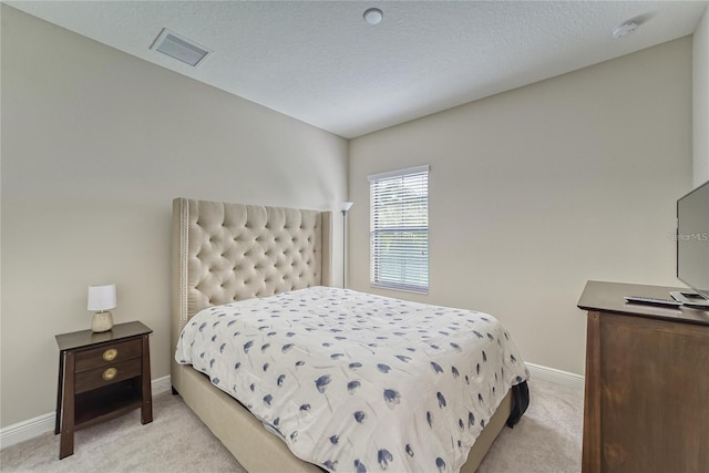 carpeted bedroom featuring a textured ceiling