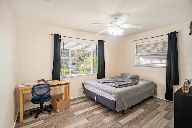 bedroom with light hardwood / wood-style floors and ceiling fan