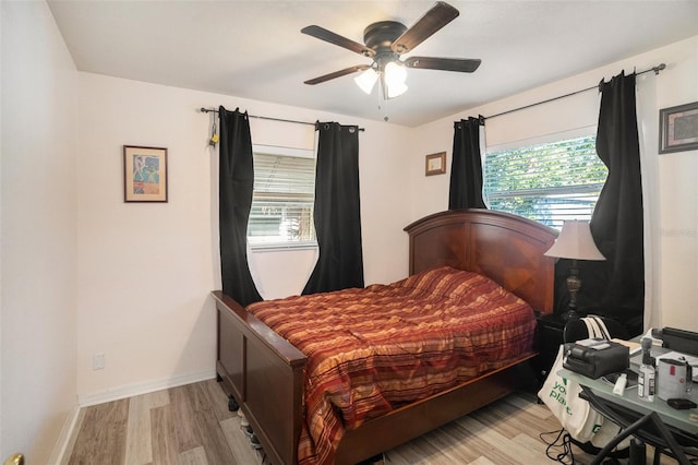 bedroom with light hardwood / wood-style flooring and ceiling fan