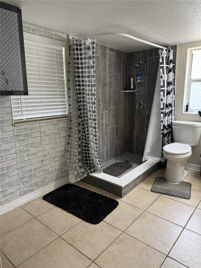 bathroom with curtained shower, tile patterned floors, toilet, and a textured ceiling