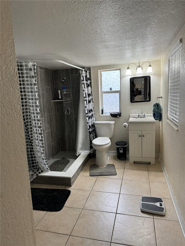 bathroom with vanity, tile patterned floors, a textured ceiling, and a shower with shower curtain