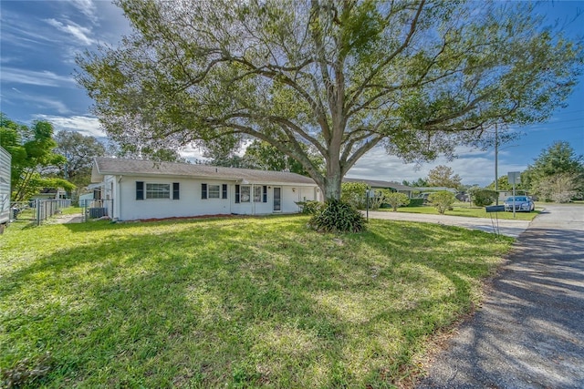 ranch-style house with a front lawn