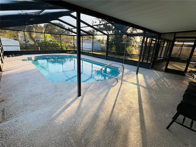 view of swimming pool featuring a shed, a lanai, and a patio area