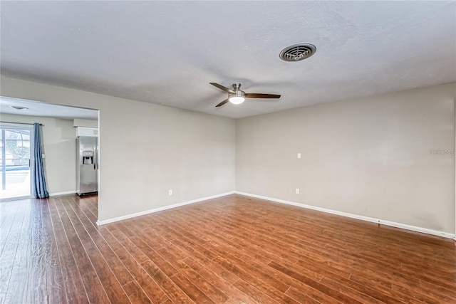 empty room with ceiling fan and dark wood-type flooring