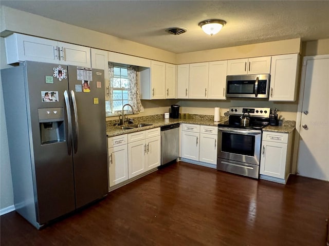 kitchen with sink, white cabinetry, and stainless steel appliances