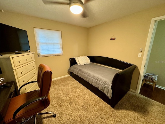 bedroom featuring ceiling fan and dark carpet