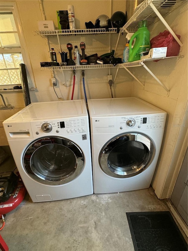 clothes washing area with washing machine and clothes dryer