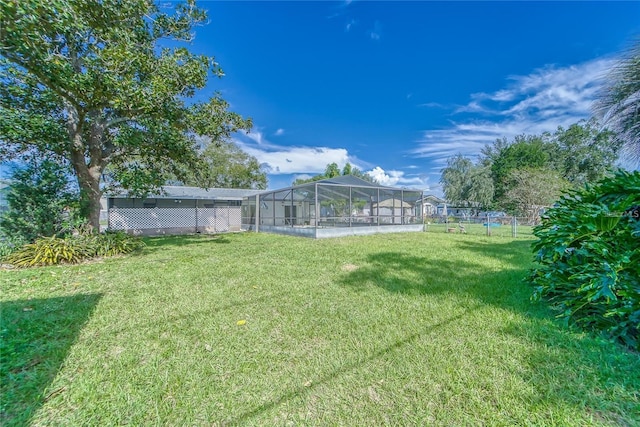 view of yard with glass enclosure