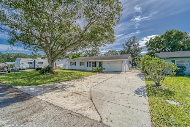 single story home featuring a garage and a front lawn