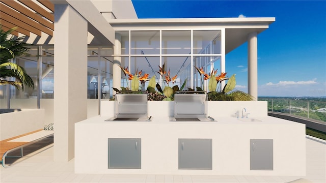 view of patio with an outdoor kitchen and sink