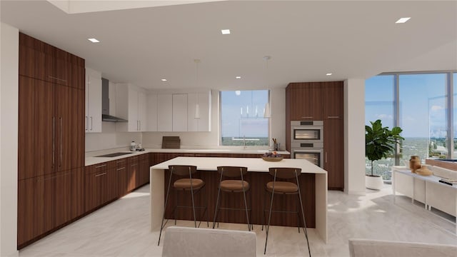 kitchen featuring white cabinetry, wall chimney exhaust hood, decorative light fixtures, black electric cooktop, and a kitchen island