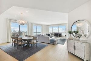 dining room with hardwood / wood-style flooring and a notable chandelier