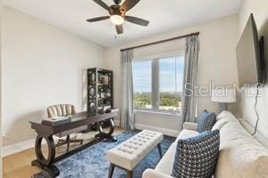 home office featuring hardwood / wood-style floors and ceiling fan