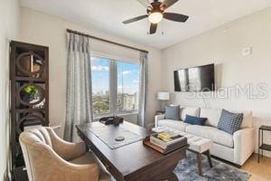 living room with hardwood / wood-style floors and ceiling fan