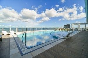 view of pool with a patio area and a water view