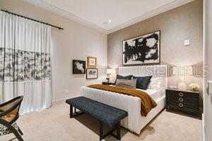 bedroom with light colored carpet and ornamental molding