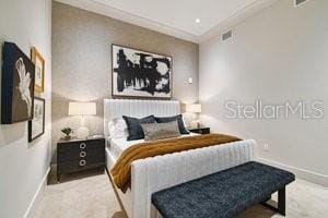 bedroom with light colored carpet and ornamental molding