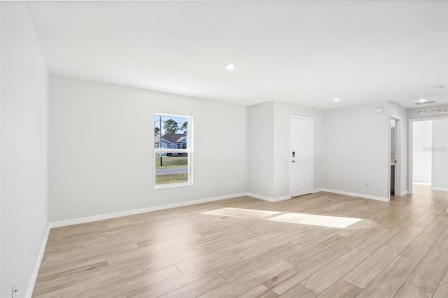 empty room with light hardwood / wood-style floors