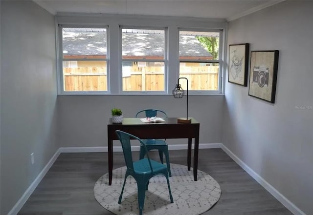 home office with crown molding and dark wood-type flooring