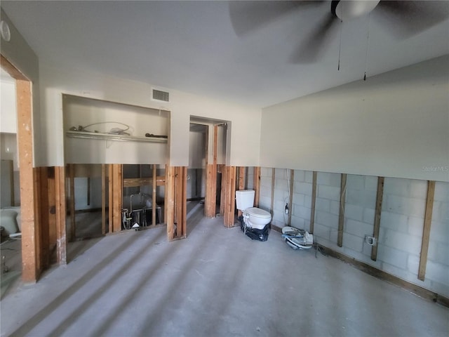 interior space featuring ceiling fan and concrete floors