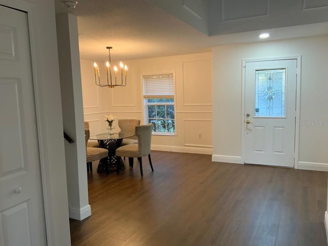 foyer with a chandelier and dark wood-type flooring