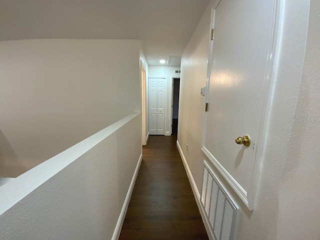 hall with dark wood-type flooring