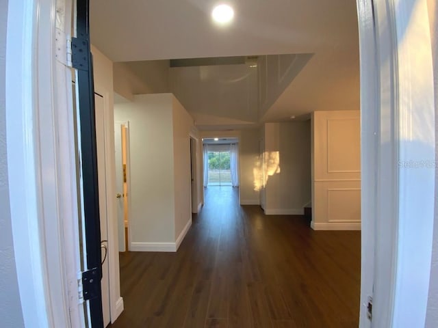 hallway with dark hardwood / wood-style flooring