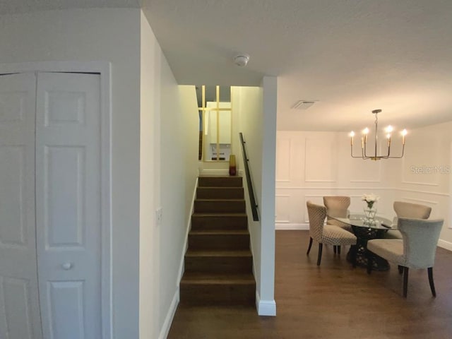 dining space featuring a chandelier and dark wood-type flooring