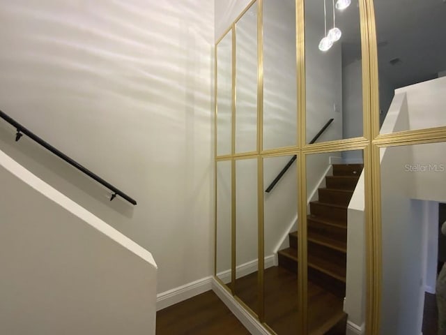 staircase with hardwood / wood-style flooring