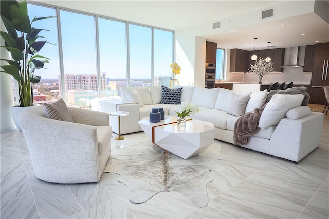 living room with a healthy amount of sunlight and a wall of windows