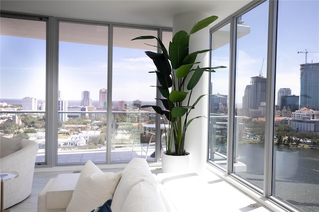 living room with a water view and a wall of windows